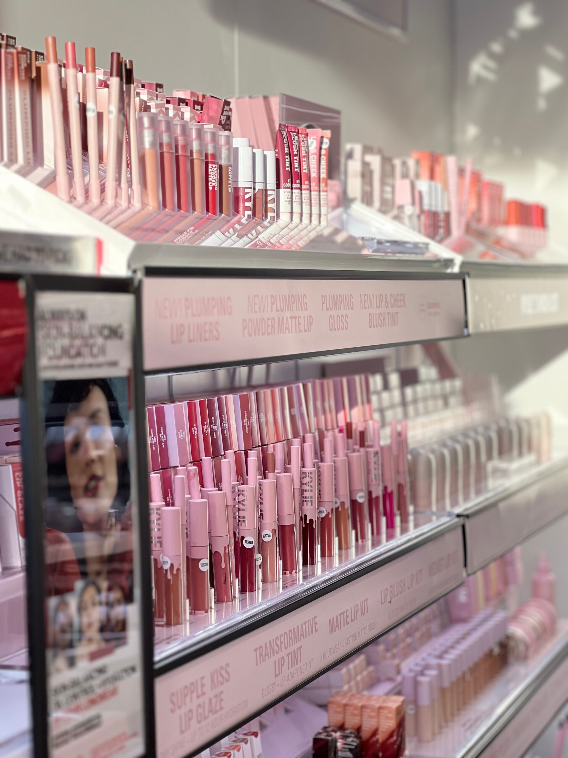 Vivid display of various lip products on shelves. Perfect for beauty and retail concepts.